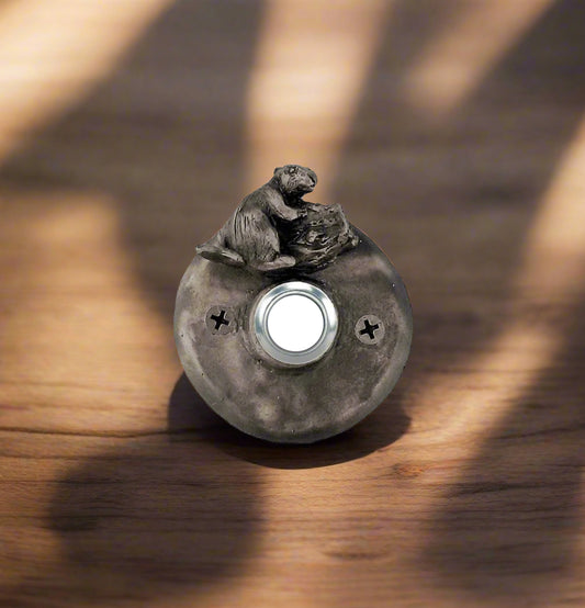 Round bronze doorbell with beaver gnawing a tree branch