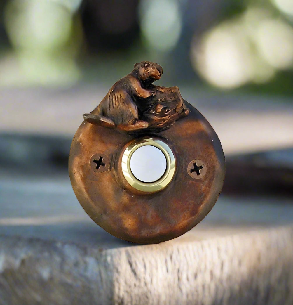 Round bronze doorbell with beaver gnawing a tree branch