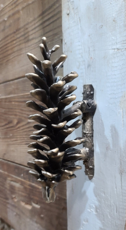 Rustic bronze door knocker, white pine cone