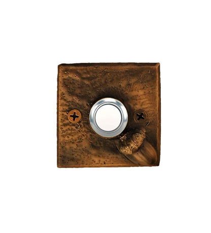Square bronze doorbell plate with acorn in lower right corner